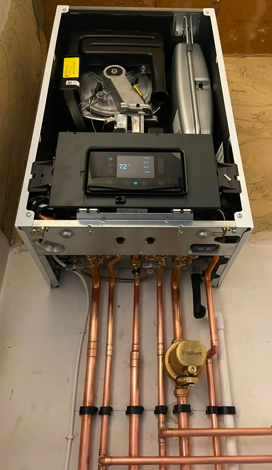 Vaillant boiler open for diagnostic repair showing burner, controls display and copper pipework, Heat Solution London