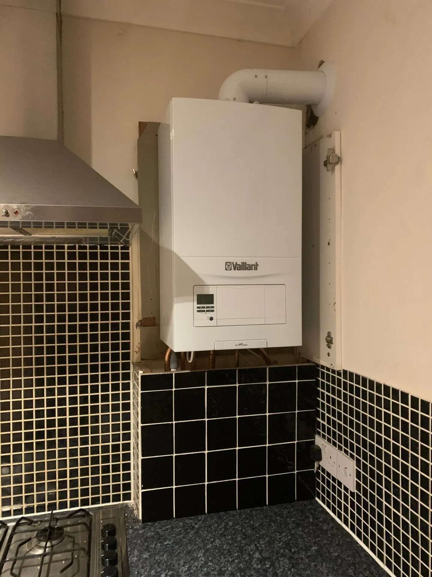 Vaillant system boiler installation in a utility cupboard, Ashford, Surrey